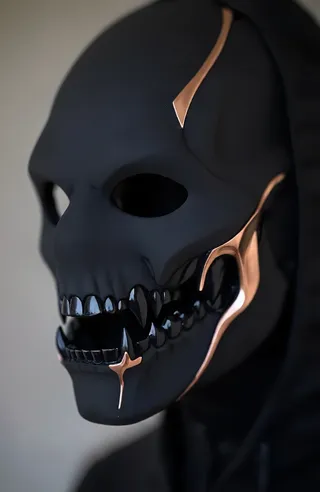 Close-up of a matte black half-mask with sleek aerodynamic design, featuring deep black demonic teeth and shiny copper accents on front and sides.