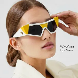 Stylish high-end triangular sunglasses with yellow tint and white coloring worn by a model, showcasing luxury product design.