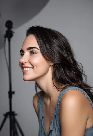 Close-up portrait of a smiling woman with long dark messy hair in a photostudio setting with soft bokeh light and studio background
