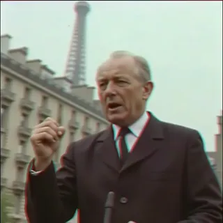 Vintage 90s VHS-style image of a politician giving a passionate speech with fist raised, Parisian buildings and the Eiffel Tower in the background.