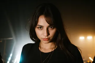 Close-up portrait of a beautiful woman at a techno rave with dramatic flash lighting and dark background.