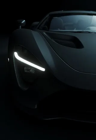 Close-up of a sleek black supercar front under low light with glowing LED headlights, matte and glossy textures, and carbon fiber details.