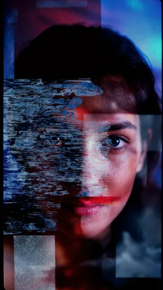 Close-up abstract portrait of a woman with textured overlays, emotional distortion effects, and vibrant blues and reds creating a dramatic and artistic mood.