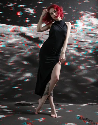 Full-body portrait of a barefoot woman with red hair, green eyes, and tattoos wearing a black high-low dress with digital glitches and a galactic battlefield backdrop.