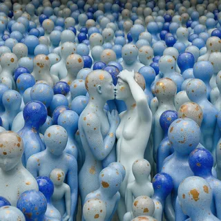 Intricate crowd of crackled glass humanoid figures in shades of ultramarine blue, blue gray, and rosegold speckles, featuring a kissing couple in the center, outdoors with water theme.