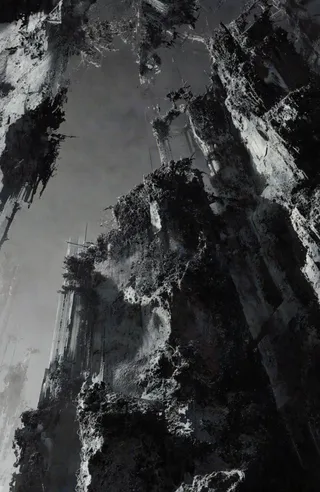 Black and white photograph showing abstract towering structures with jagged, textured edges rising upward with a low-angle perspective, having a dark and moody atmosphere.