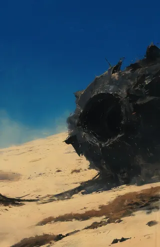 Large dark metallic cannon, damaged and corroded, partially buried in a bright sandy desert under a clear deep blue sky, with patches of dry brown grass.