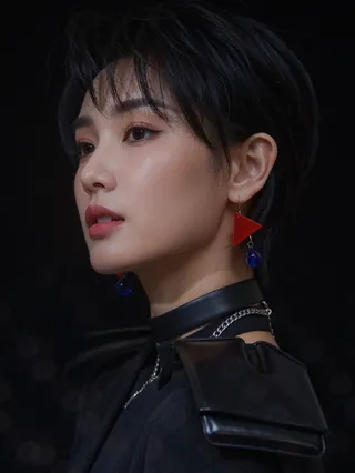 Close-up cinematic portrait of a young Korean woman with a sleek black pixie cut, sharp high-contrast lighting, wearing layered metallic necklaces and mismatched geometric earrings against a black background.