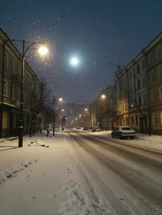 Snow-covered street in a Russian neighborhood at night with Soviet apartment buildings, street lamps glowing, falling snow, and parked Lada cars under moonlight.