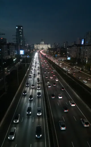 Night view from a drone showing a wide highway filled with cars, surrounded by tall buildings with neon lights and a large neo classical government building with columns in the background.